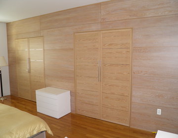 New closet doors in pickled oak incorporated with wall panels on the same color