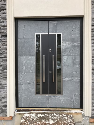 modern front door with stone exterior