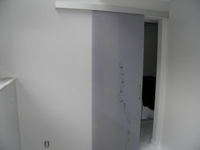 Glass door sliding on wall, lillac color, frosted decor, aluminum track, designed and crafted in Italy.
