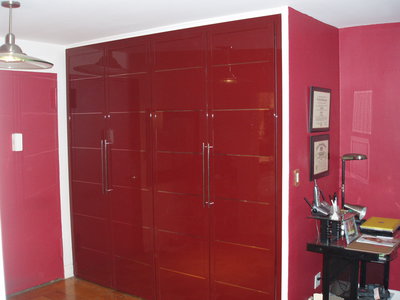 Hallway closet in red glossy finish with shiny chrome horizontal stripes, matching color door pulls