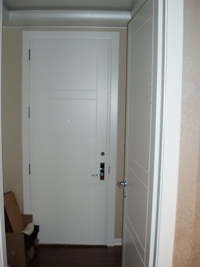 White panel applied over existing entry door to camouflage 