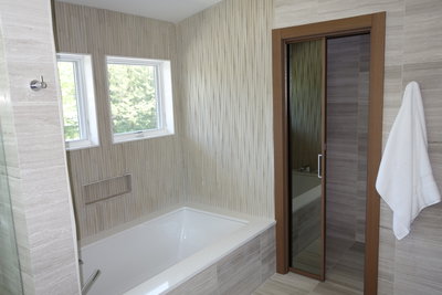 Reflective glass pocket door in Master Bath